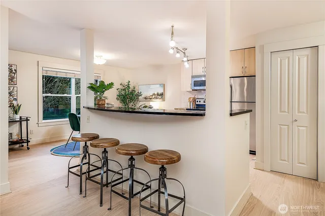 a view of a dining room with furniture and a chandelier