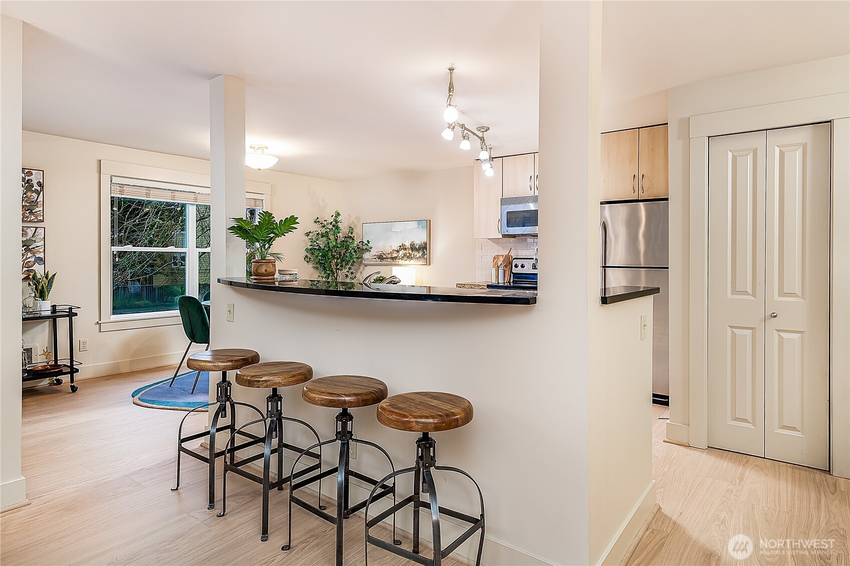 23015 Edmonds Way, Unit A214 Edmonds, WA 98020 - Photo 7 of 24 a view of a dining room with furniture and a chandelier