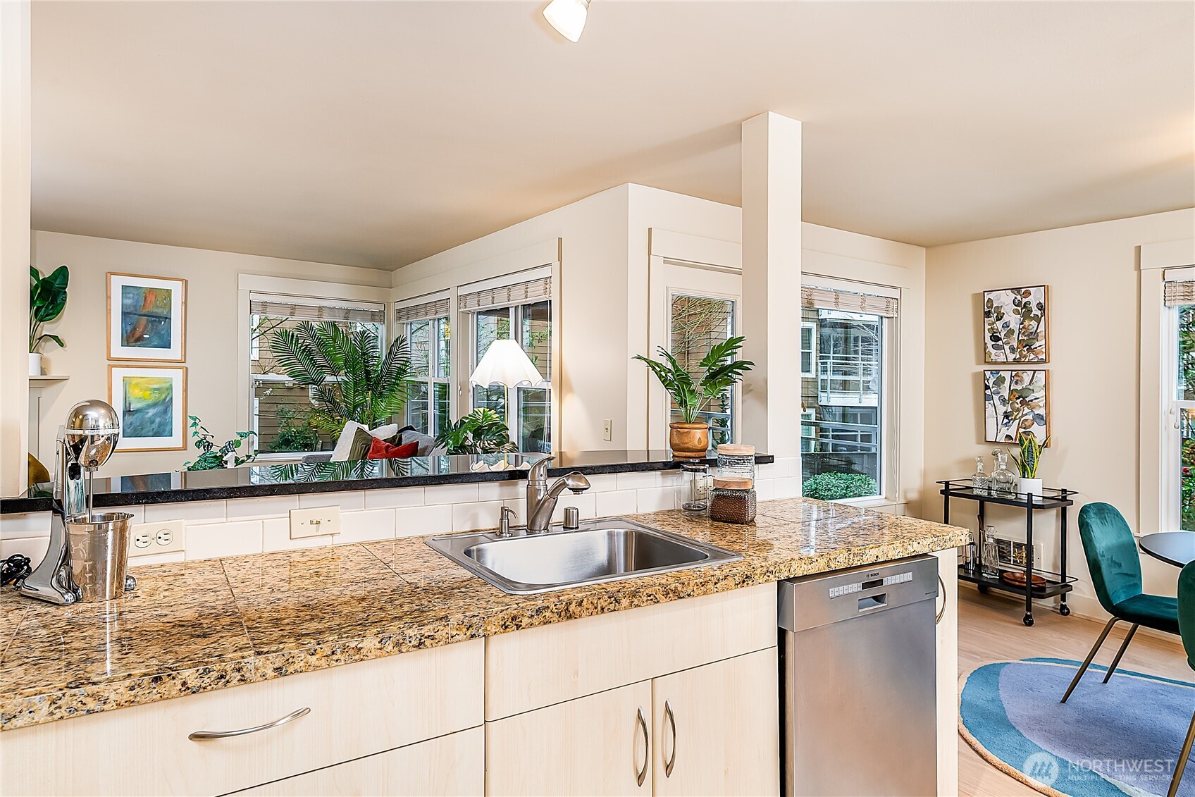 23015 Edmonds Way, Unit A214 Edmonds, WA 98020 - Photo 8 of 24 a kitchen with sink cabinets and dining table