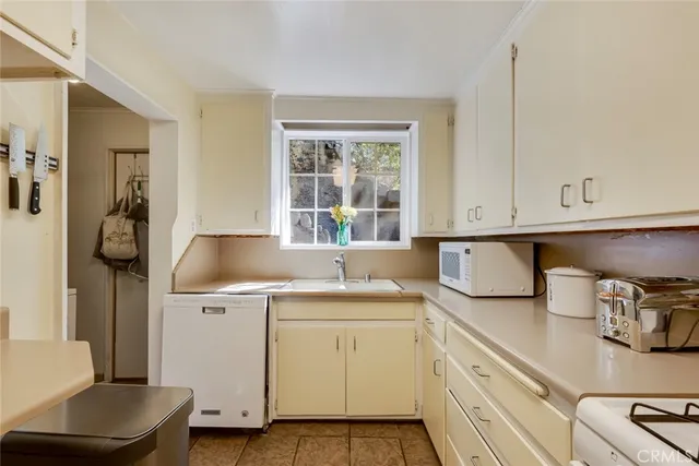 a view of a kitchen with sink dryer and washer