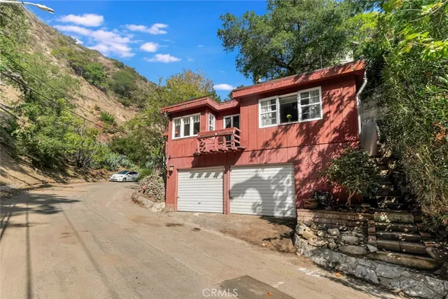 a view of a house with a yard and sitting area