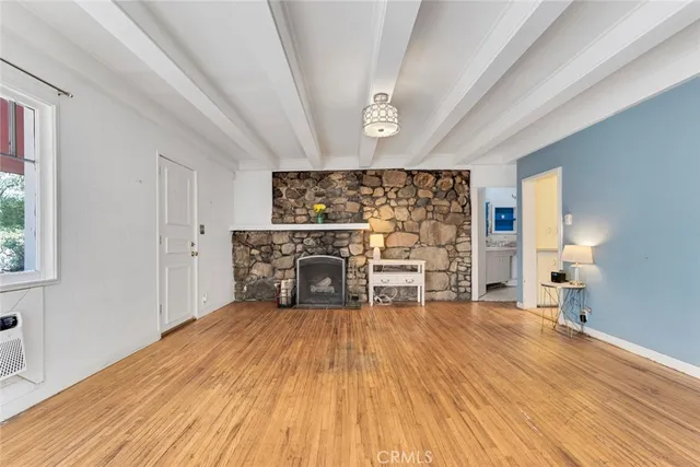 a view of a livingroom with furniture wooden floor and window