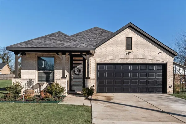 a front view of a house with garden