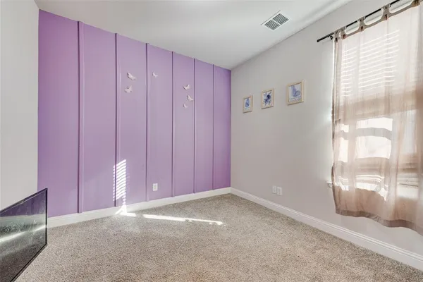 a view of a livingroom with an empty space and a window