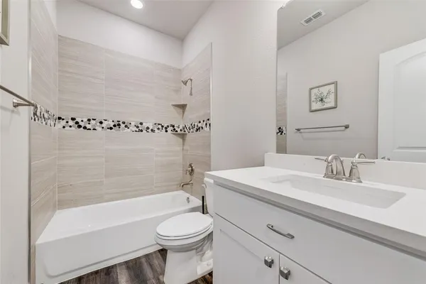 a bathroom with a sink a toilet and a bathtub