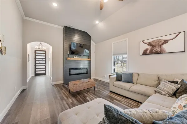 a living room with furniture and a flat screen tv