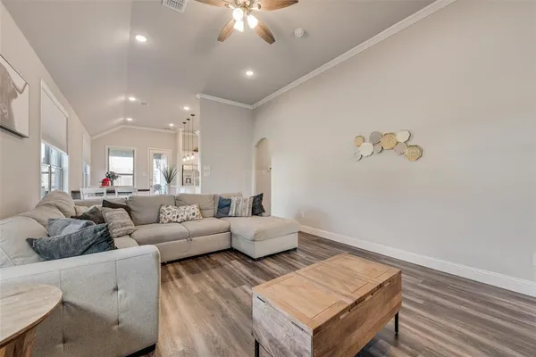 a living room with furniture and a chandelier
