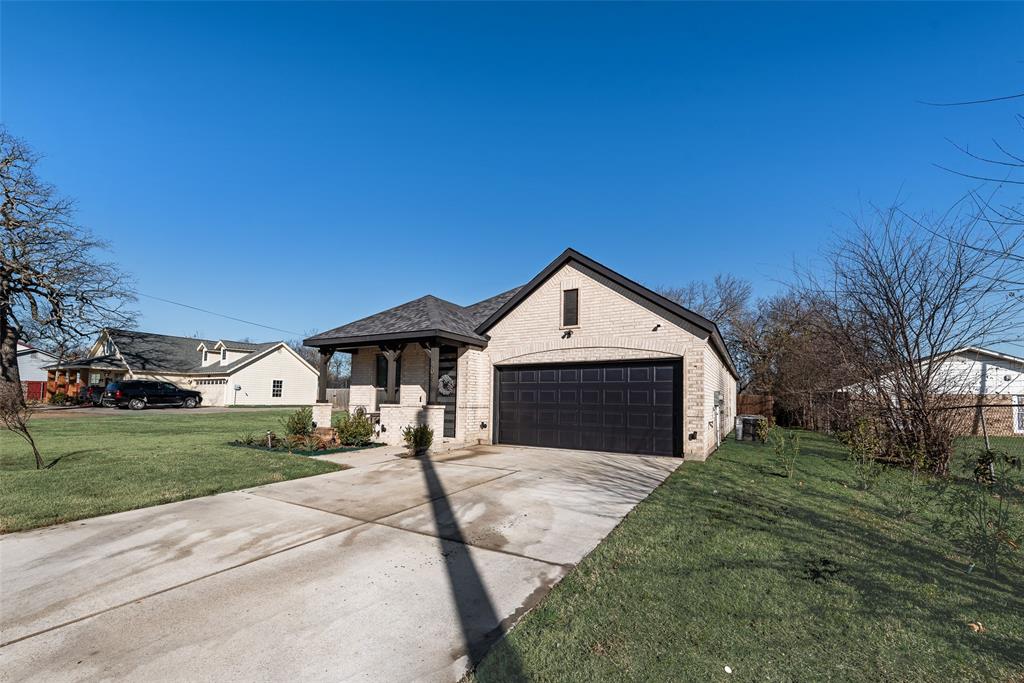 404 West Rochester Street Terrell, TX 75160 - Photo 23 of 24 a front view of a house with yard and green space