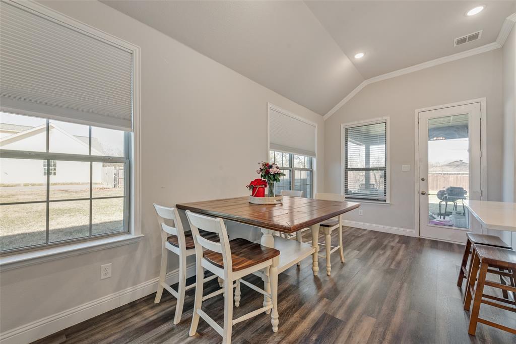 404 West Rochester Street Terrell, TX 75160 - Photo 10 of 24 a view of a dining room with furniture large windows and wooden floor
