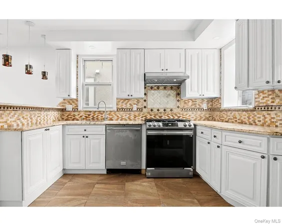 a kitchen with stainless steel appliances granite countertop a stove sink and cabinets