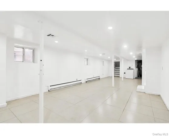 a view of a big room with kitchen and windows