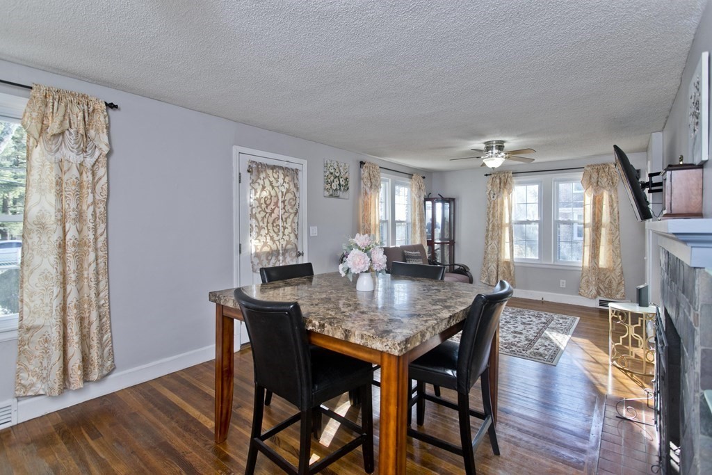 2020 Wilbraham Road Springfield, MA 01129 - Photo 13 of 37 a dining room with wooden floor a chandelier a wooden table and chairs
