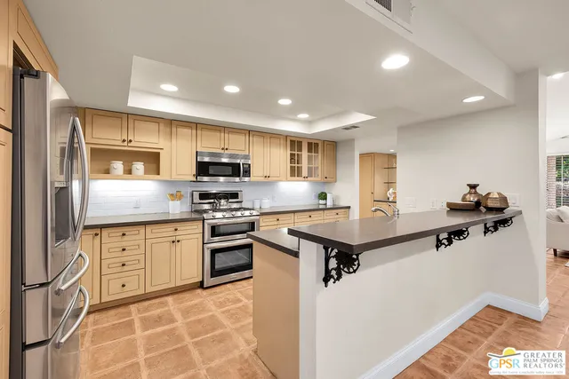 a kitchen with a sink and a stove top oven