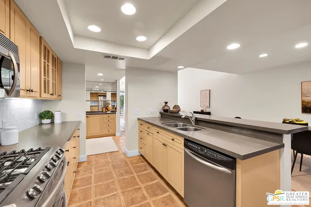 a kitchen with a sink stove and refrigerator