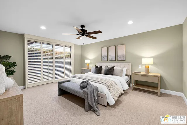 a bedroom with a bed and a tv