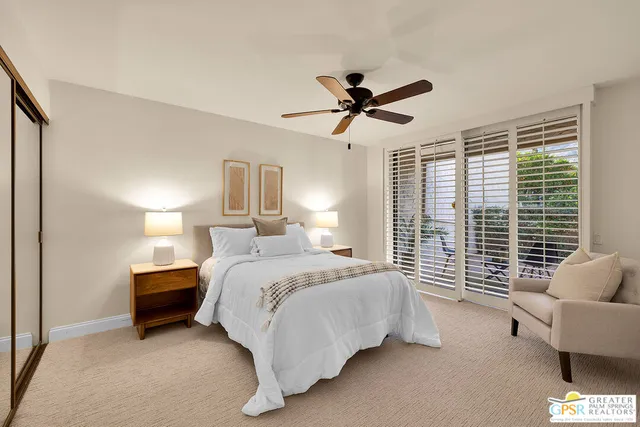 a bedroom with a large bed and a large window