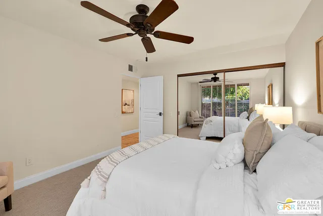 a bathroom with a granite countertop sink a toilet a mirror and shower