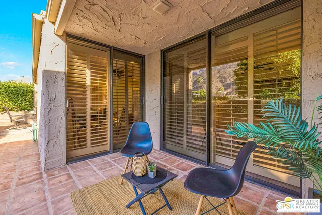 a view of balcony with a table and chairs
