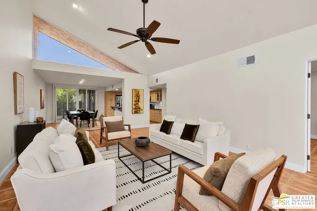 a hallway with white cabinets and wooden floor