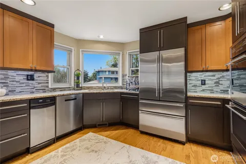 a kitchen with stainless steel appliances granite countertop a stove and a refrigerator
