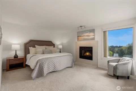 a large bedroom with a bed and a fireplace