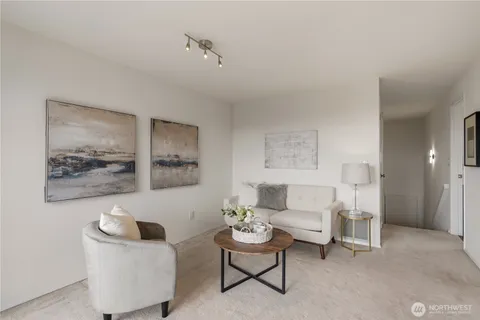 a living room with furniture and a floor to ceiling window