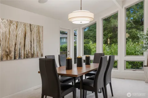 a kitchen with a table chairs refrigerator and cabinets