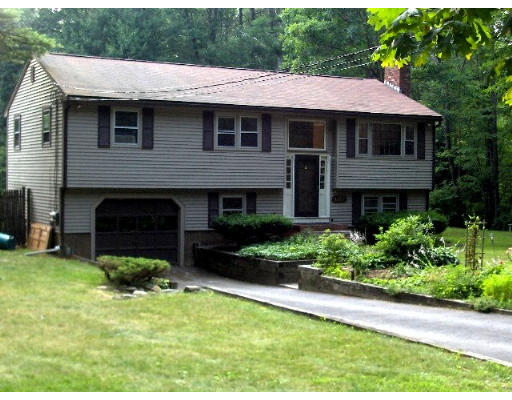 687 Townsend Road Groton, MA 01450 - Photo 1 of 17 a front view of a house with a garden
