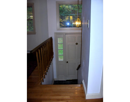 687 Townsend Road Groton, MA 01450 - Photo 12 of 17 a view of a hallway with wooden floor and staircase