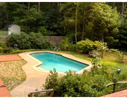 687 Townsend Road Groton, MA 01450 - Photo 2 of 17 a view of a swimming pool with a yard