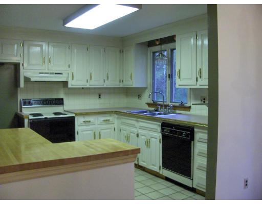 687 Townsend Road Groton, MA 01450 - Photo 3 of 17 a kitchen with stainless steel appliances granite countertop a stove and cabinets