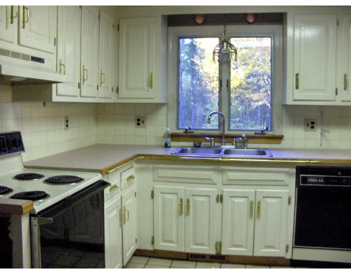 687 Townsend Road Groton, MA 01450 - Photo 4 of 17 a kitchen with stainless steel appliances granite countertop a stove and a white cabinets