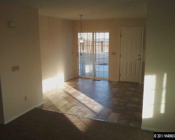 1260 Lattin Road Fallon, NV 89406 - Photo 3 of 7 an empty room with wooden floor and windows