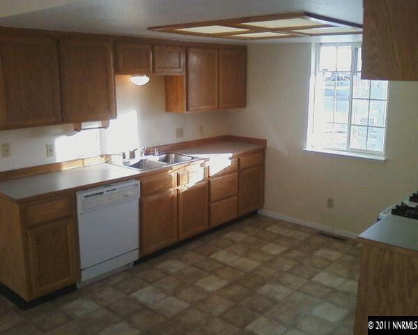 1260 Lattin Road Fallon, NV 89406 - Photo 4 of 7 a kitchen with sink cabinets and window