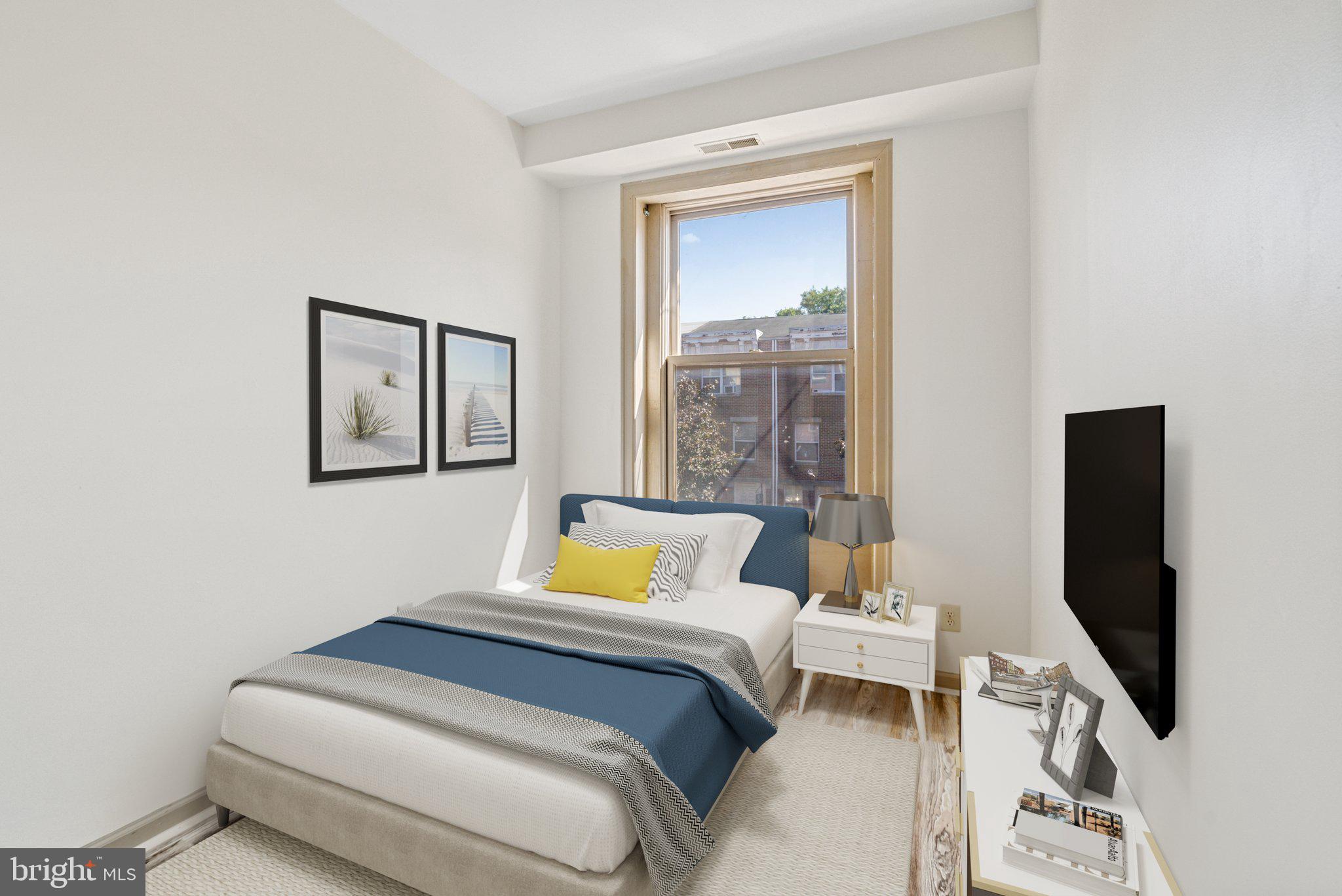 1621 West Diamond Street Philadelphia, PA 19121 - Photo 14 of 18 a bedroom with a bed and flat screen tv