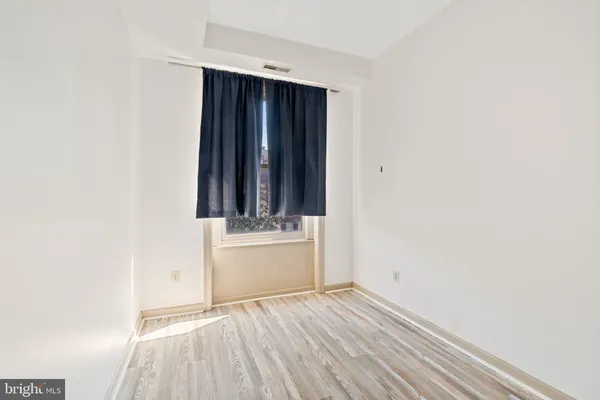 a view of room with wooden floor