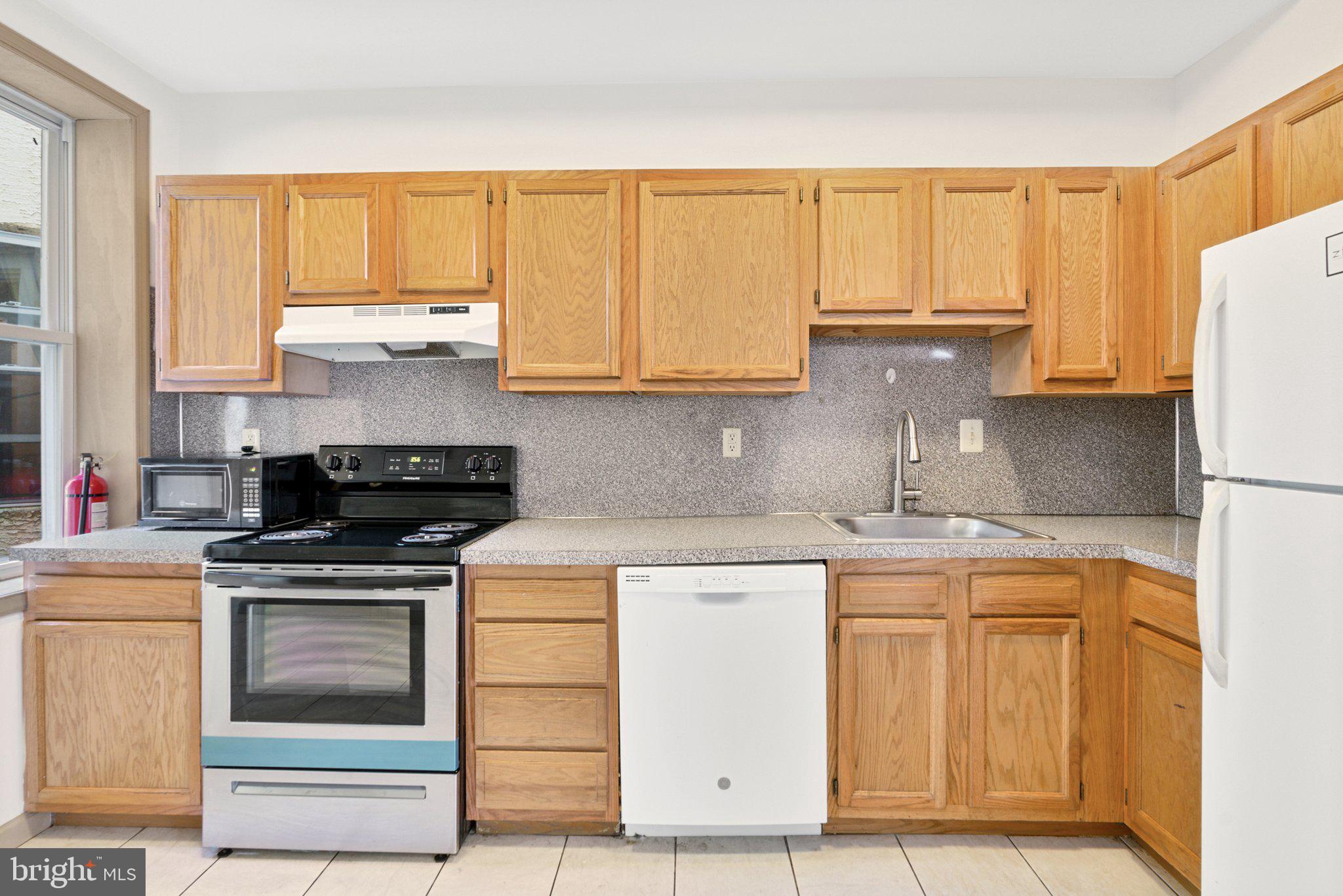 1621 West Diamond Street Philadelphia, PA 19121 - Photo 6 of 18 a kitchen with cabinets appliances and a counter space