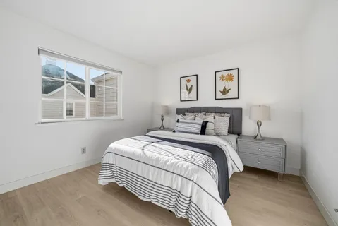 a bedroom with a bed and a night stand