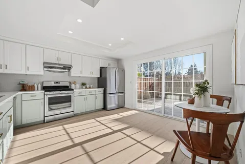 a kitchen with a stove a sink and a refrigerator