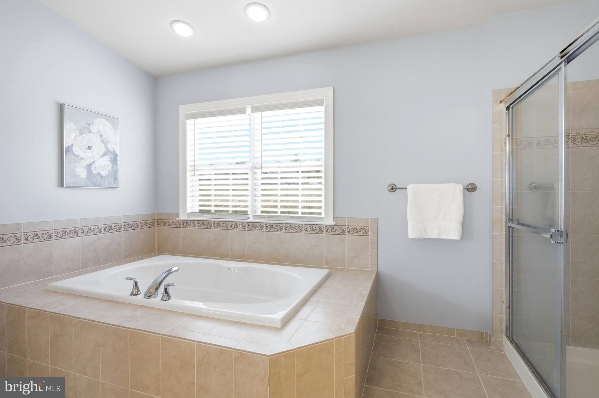 18475 Kerill Road Triangle, VA 22172 - Photo 86 of 99 a bathroom with a bathtub and a shower