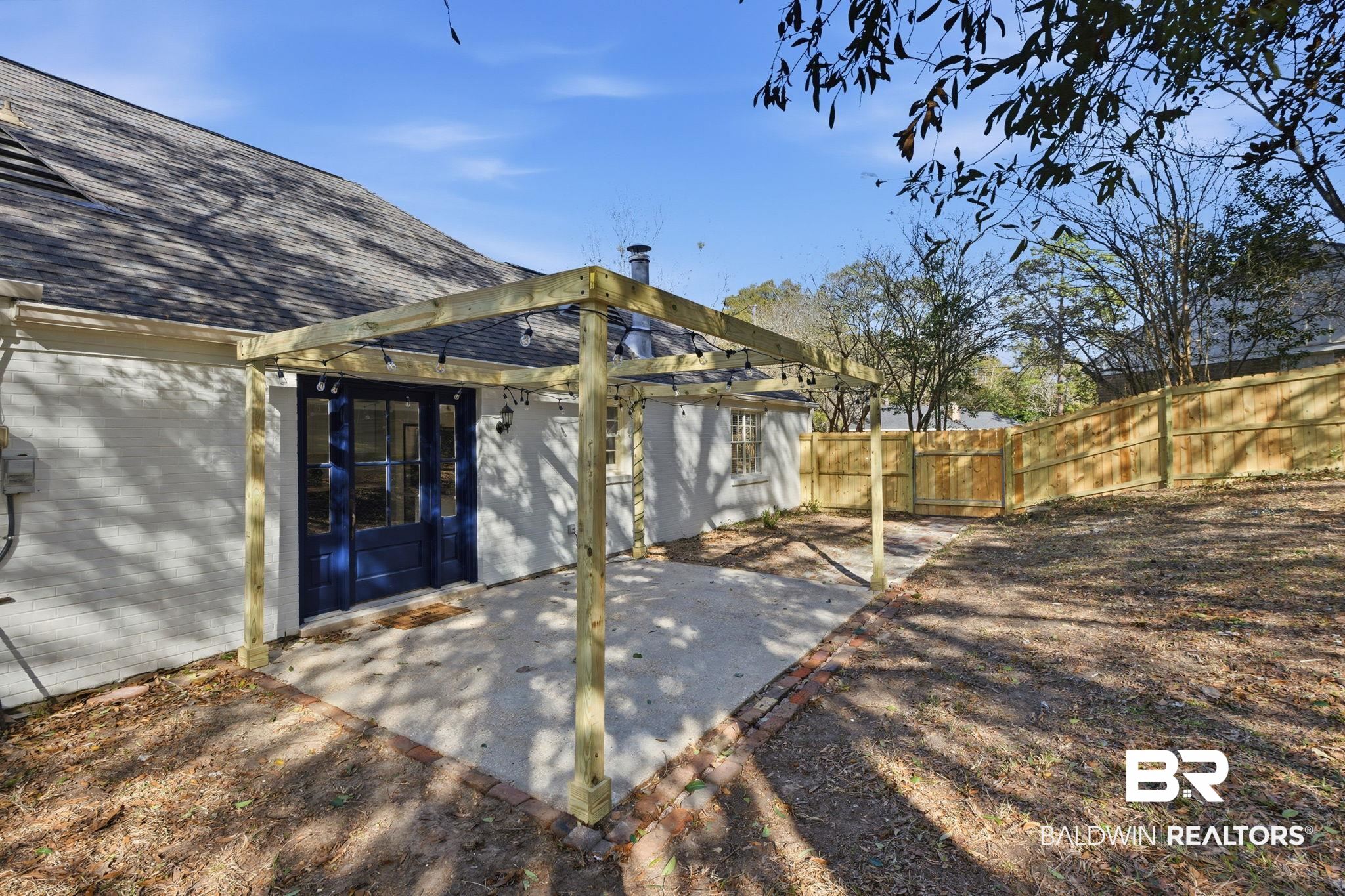 814 Nassau Drive Mobile, AL 36608 - Photo 37 of 44 Back of property featuring a gate, a fenced backyard, a patio area, and a shingled roof