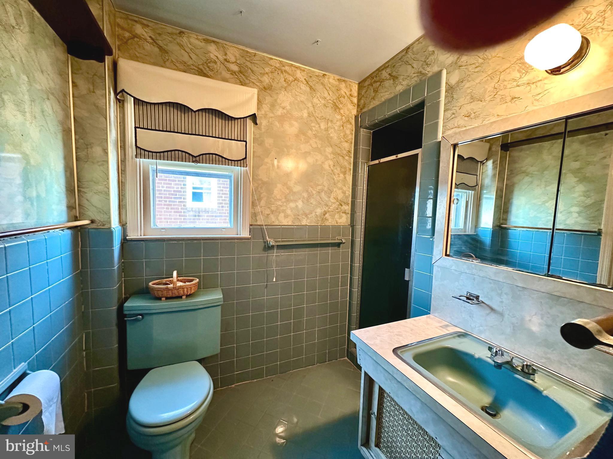 2740 Mower Street Philadelphia, PA 19152 - Photo 17 of 23 a bathroom with a toilet sink vanity and mirror