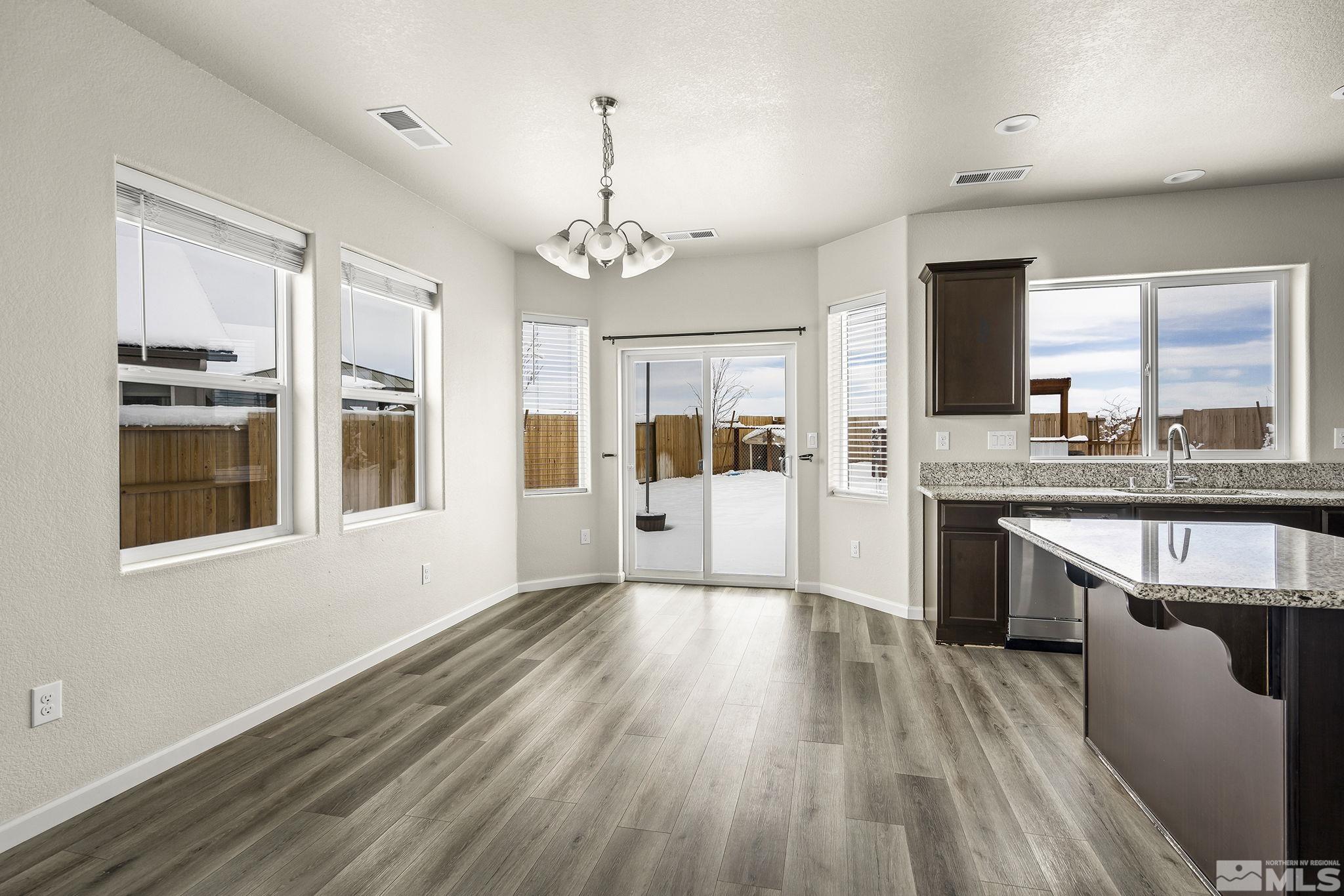 14420 Leiden Drive Reno, NV 89506 - Photo 6 of 16 a large kitchen with a wooden floor and outdoor space