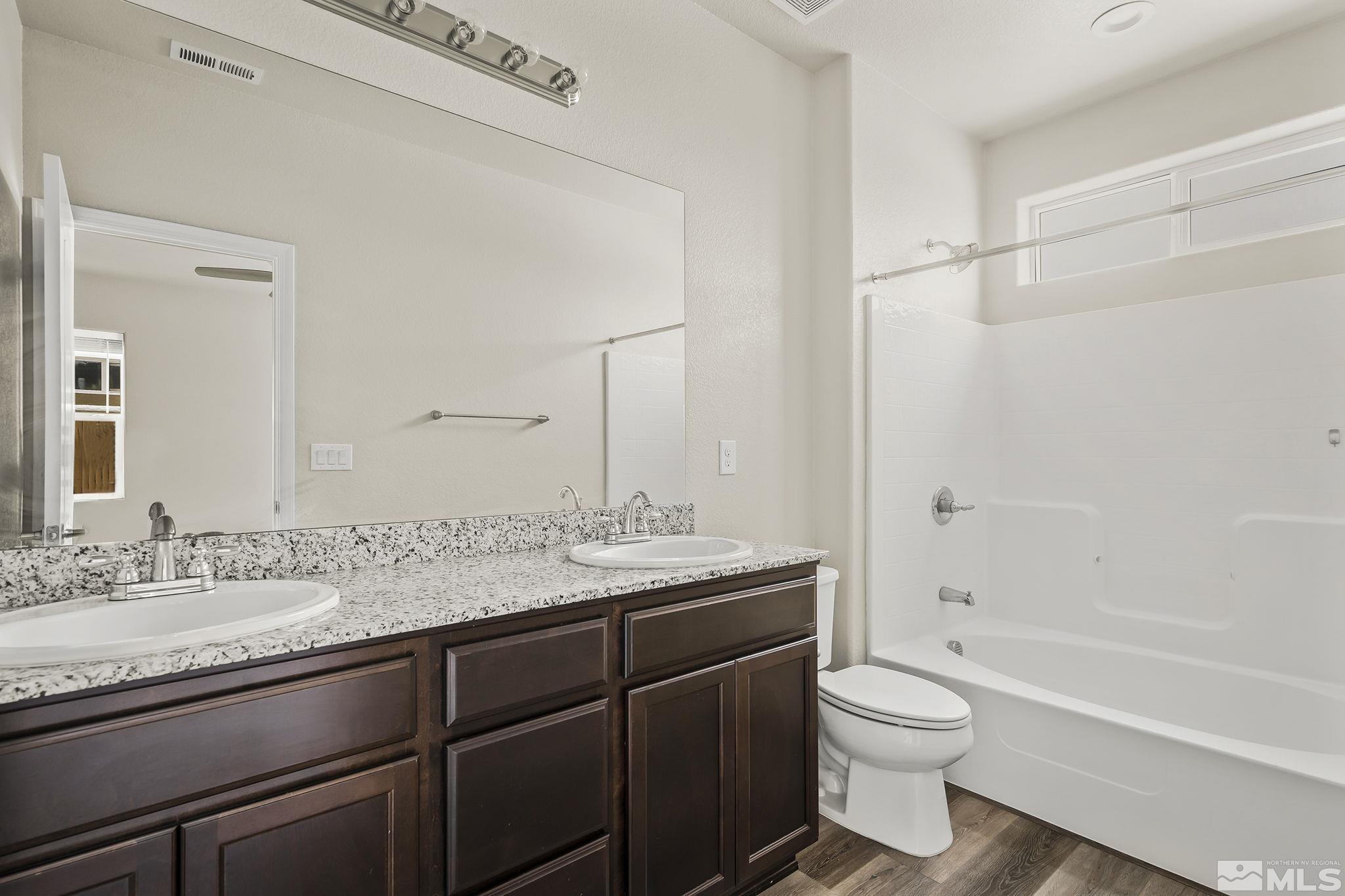 14420 Leiden Drive Reno, NV 89506 - Photo 10 of 16 a bathroom with a granite countertop sink toilet and shower