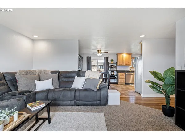 a living room with furniture and a wooden floor