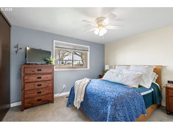 a bedroom with a bed and a dresser