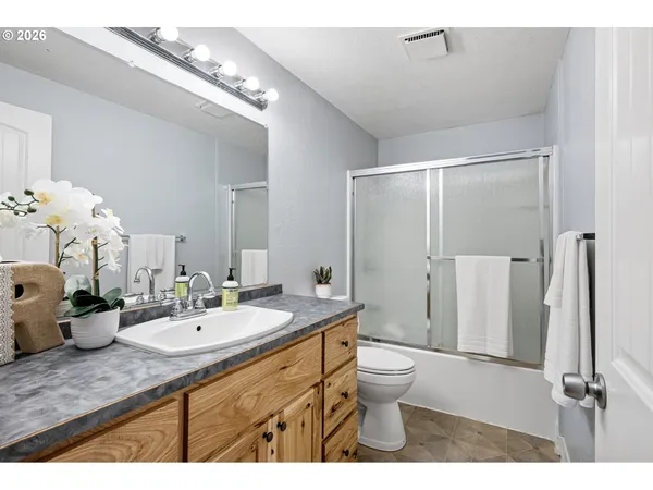a bathroom with a double vanity sink mirror and toilet