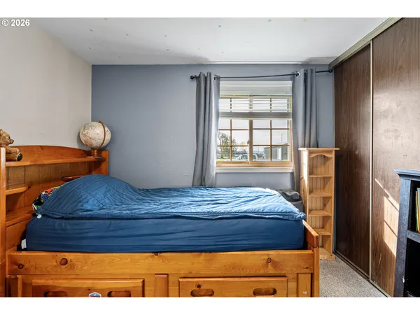 a bedroom with a bed and window