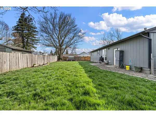 a backyard of a house with table and chairs