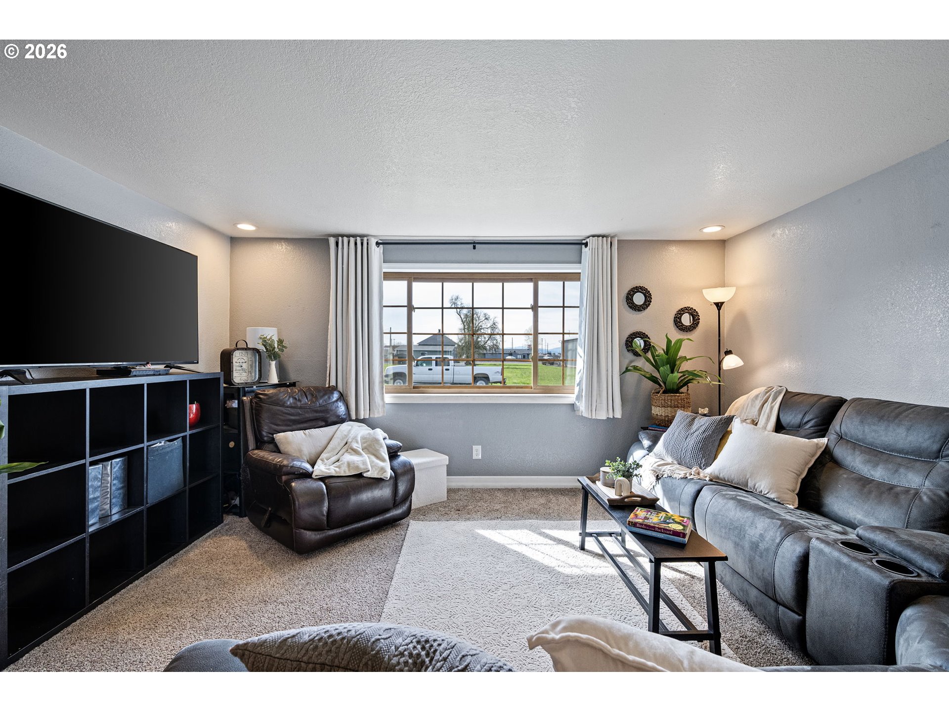86 East 2nd Street Halsey, OR 97348 - Photo 9 of 36 a living room with furniture and a flat screen tv